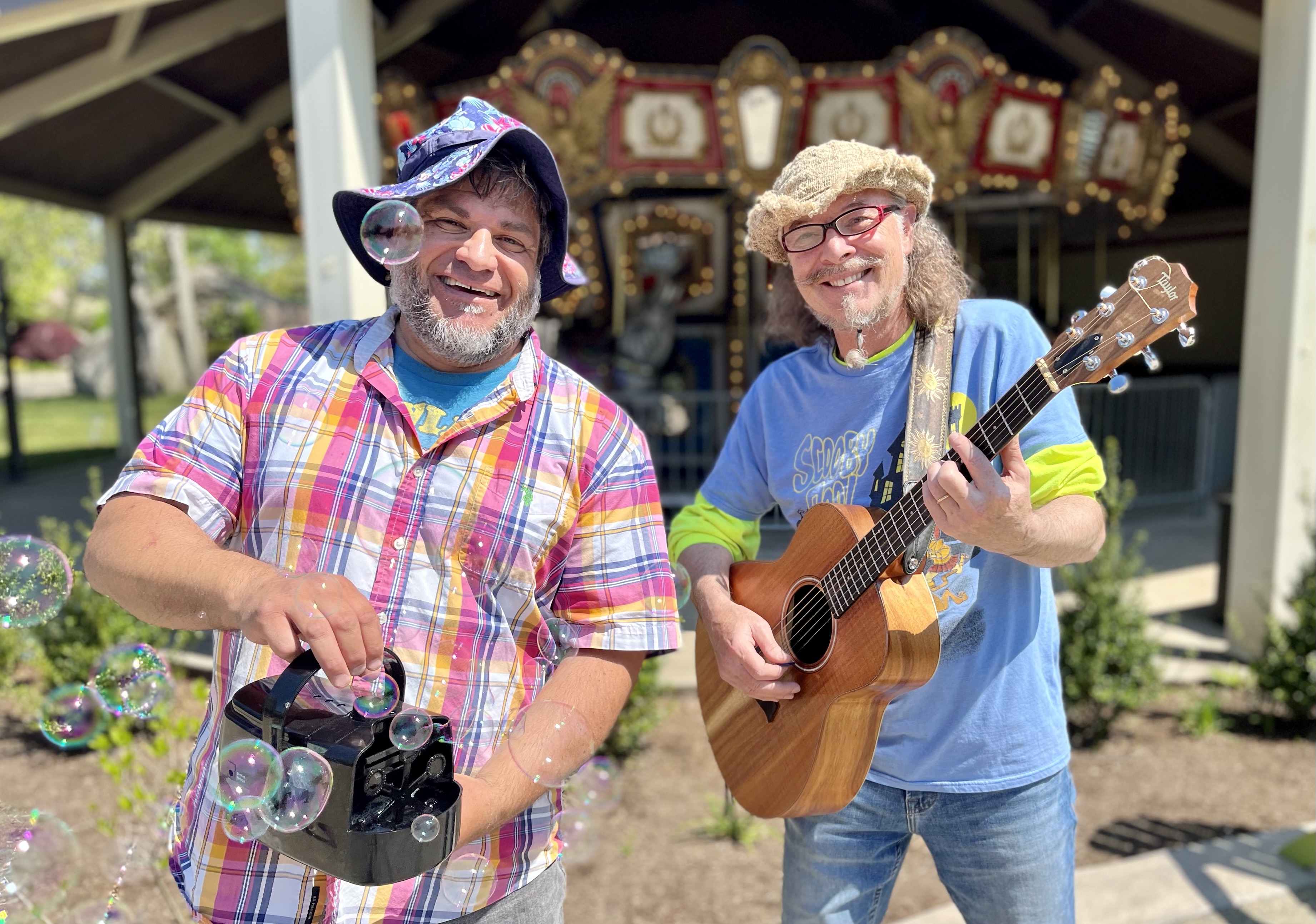 Mr. Vinny with a bubble machine and Mr. Tom holding his guitar.