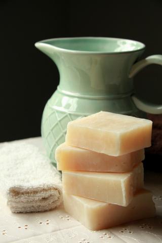 bars of soap next to green pitcher.