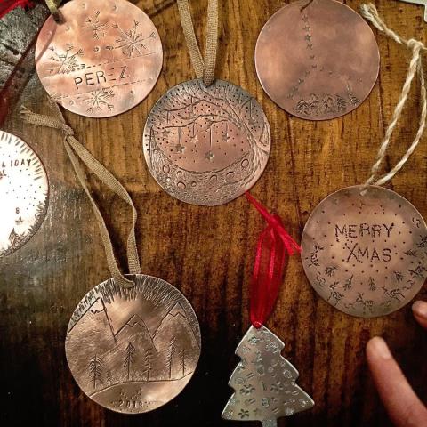 Handmade copper ornaments on a wooden table.