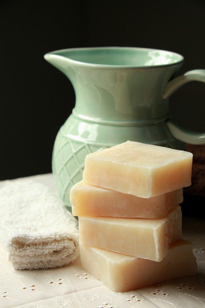 bars of soap next to green pitcher.