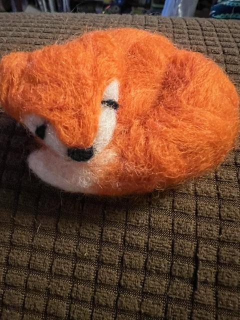 Needle felted fox laying down