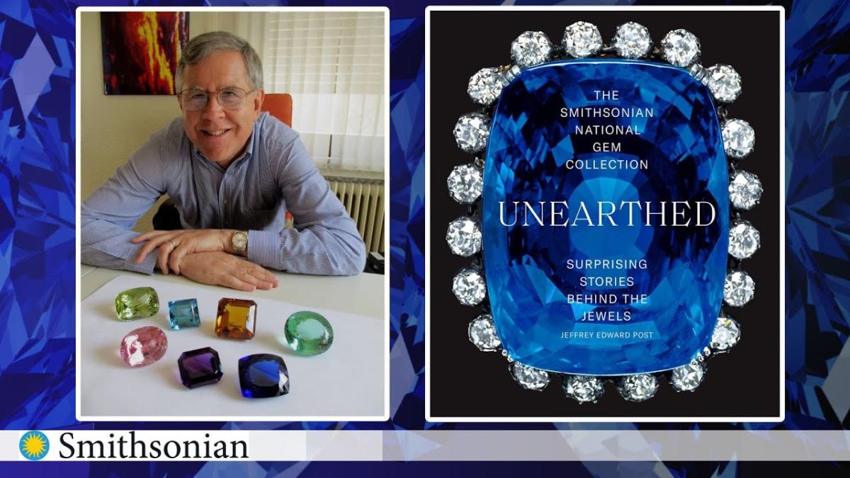 Photo of author with large gems and his book cover