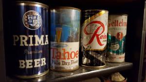 A line of four beer cans