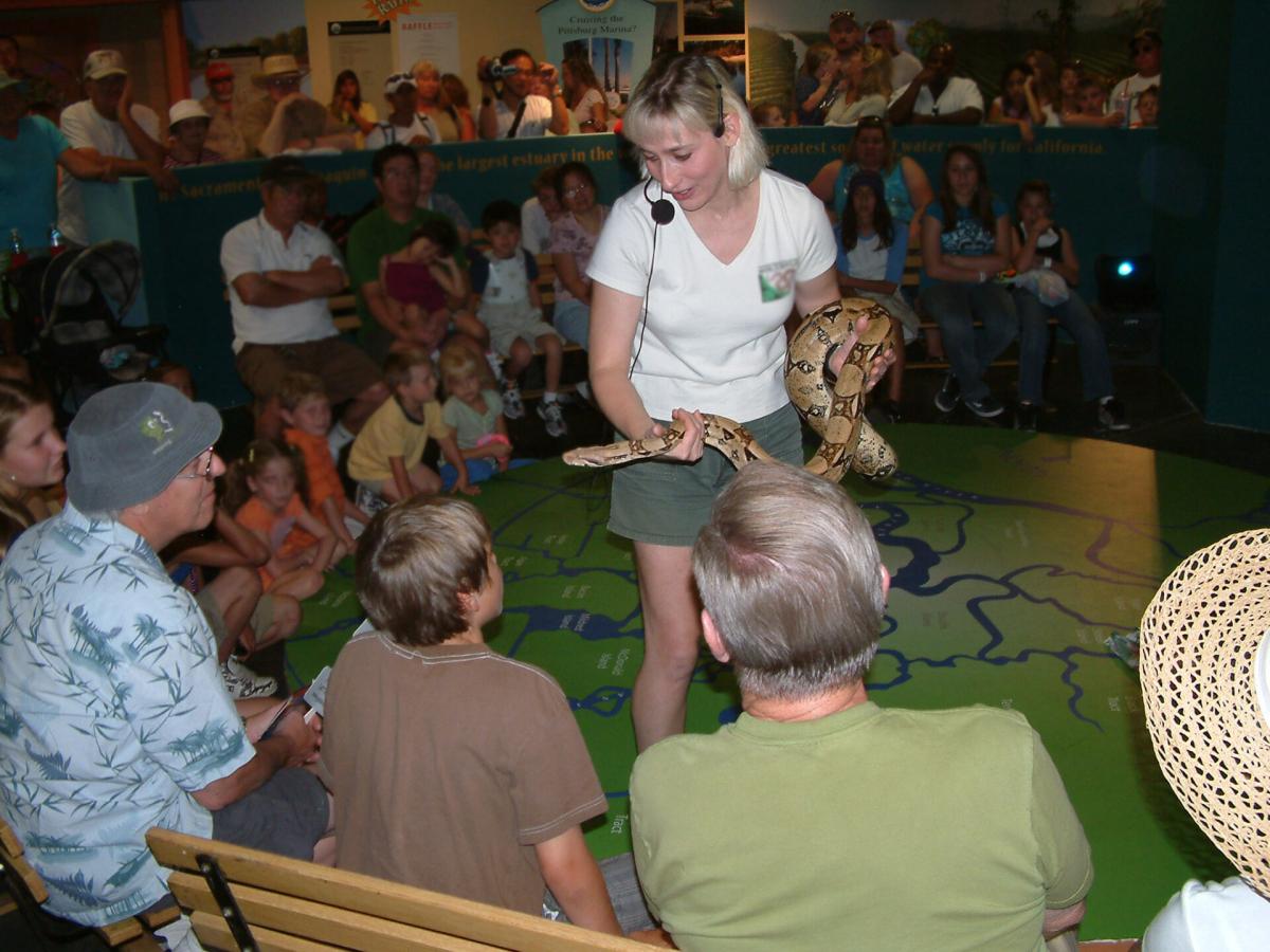 Joy showing a snake to a group of program participants.