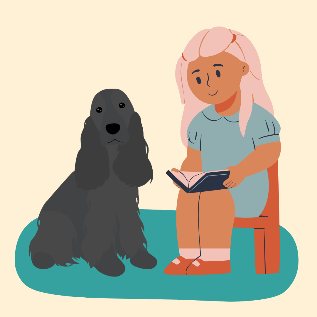 Child sitting in red chair, reading to a black spaniel dog sitting next to her.