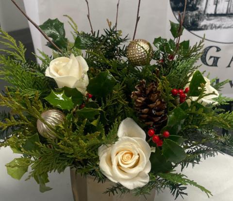 floral arrangement with white flowers and greens